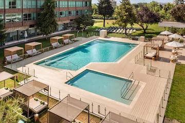 a swimming pool with a deck and chairs