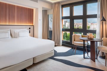 a room with a bed and a table and chairs