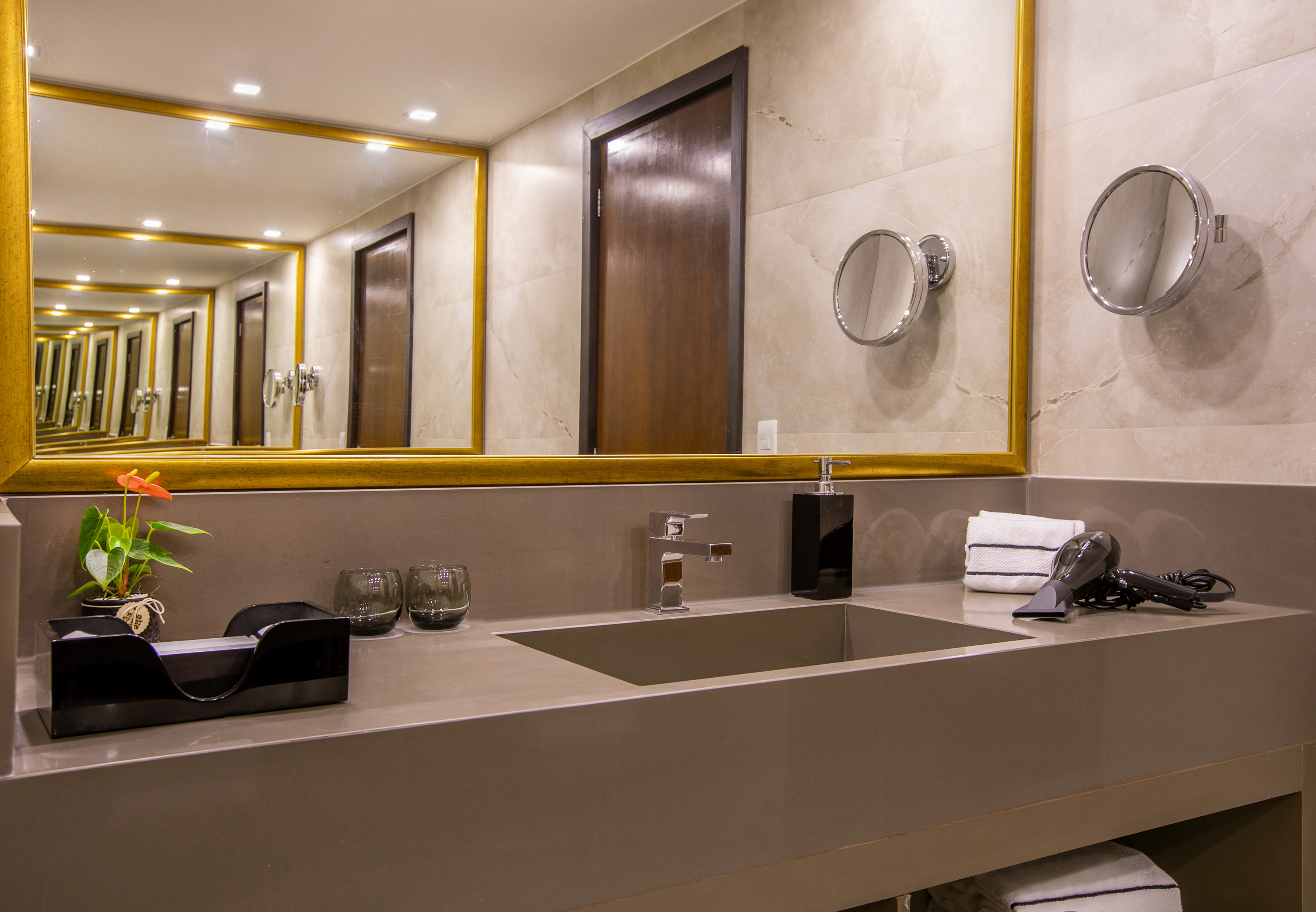 Modern bathroom vanity, gold mirror with infinite reflection, single sink.