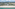 Tropical beach resort with luxury villas, pools, sandy shore, and blue ocean.