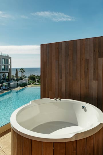 a white round tub next to a pool