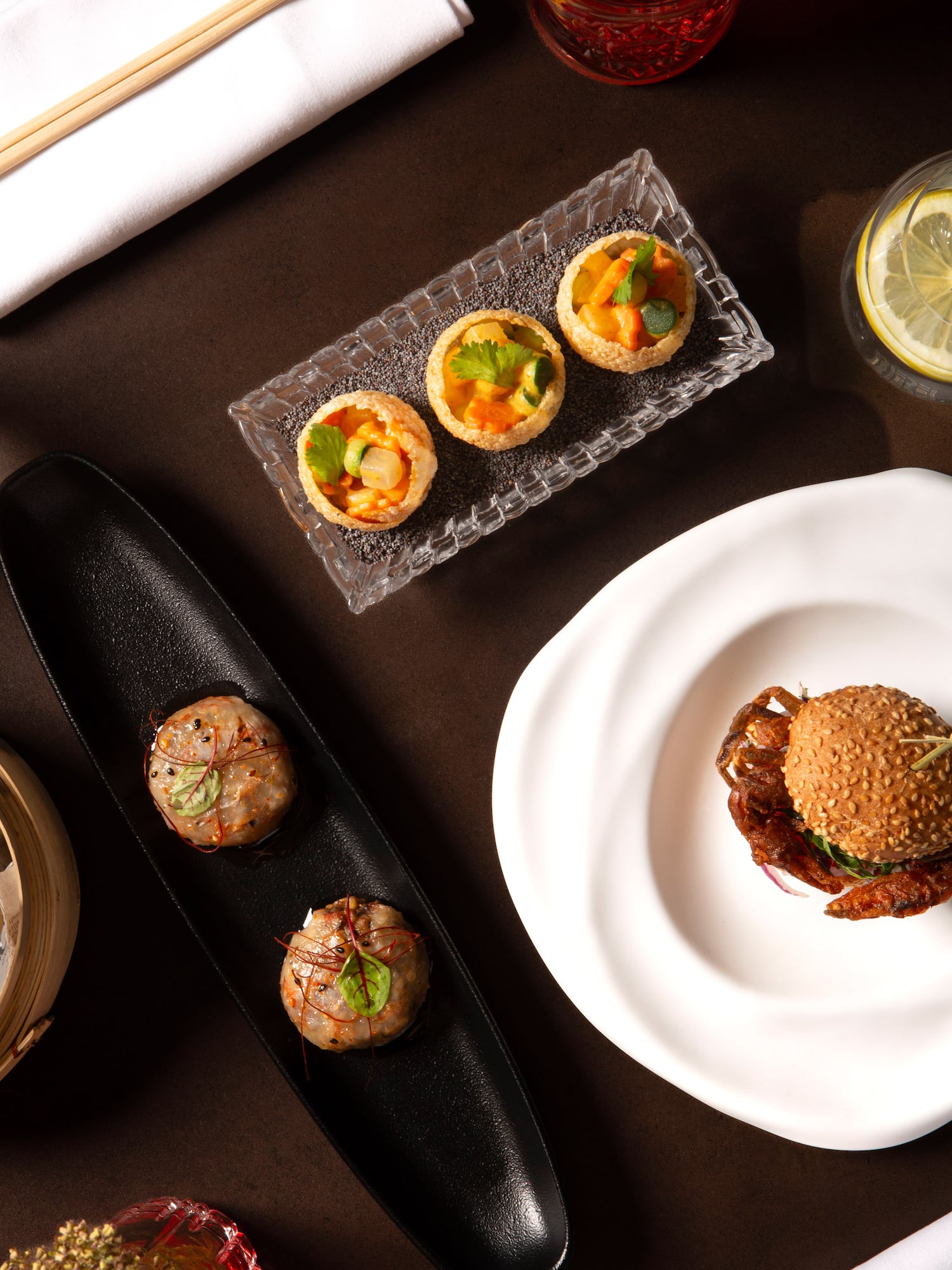 Gourmet appetizers: Pani Puri, soft-shell crab burger, dumplings, and cocktails.