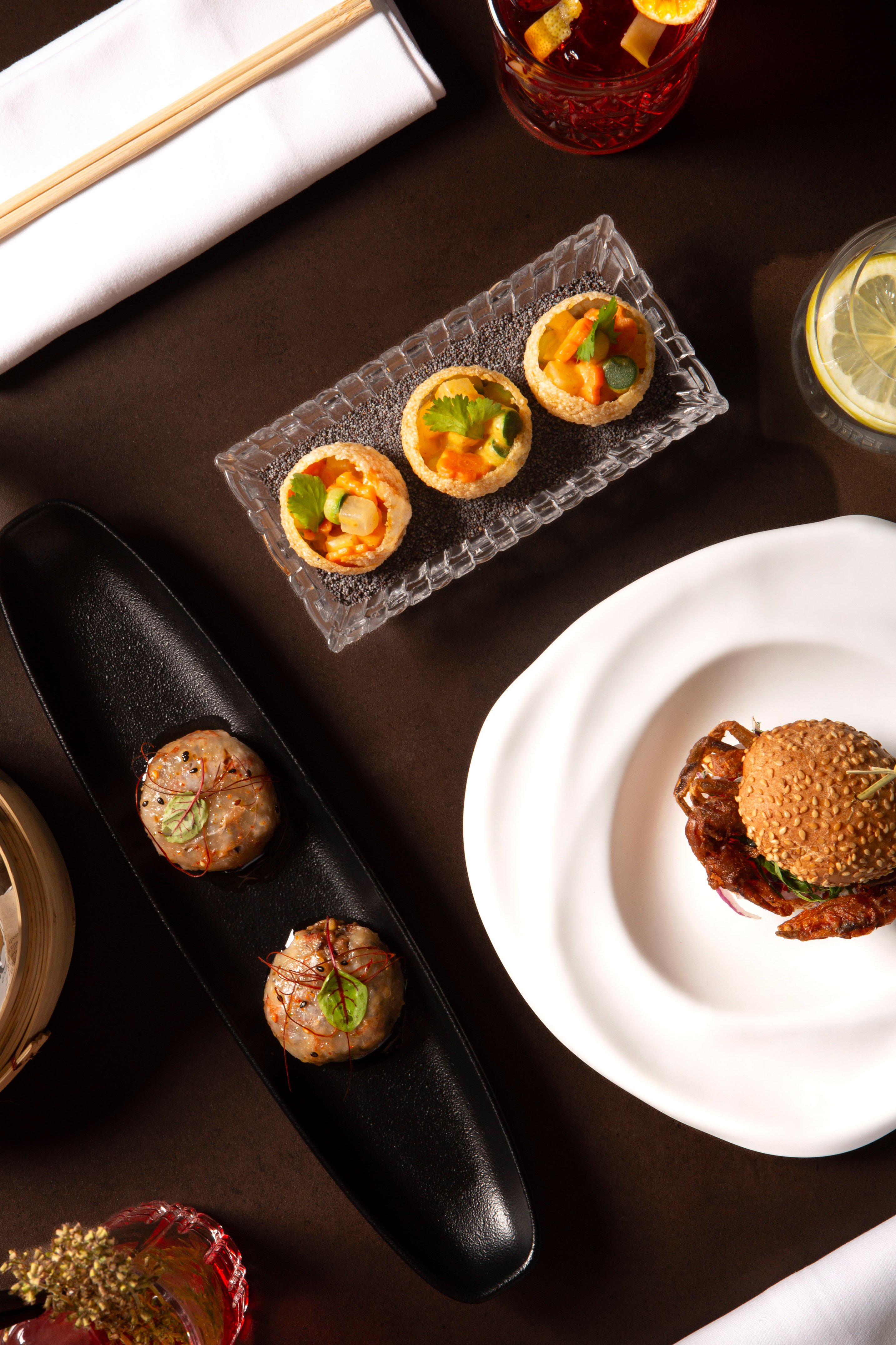 Gourmet appetizers: Pani Puri, soft-shell crab burger, dumplings, and cocktails.