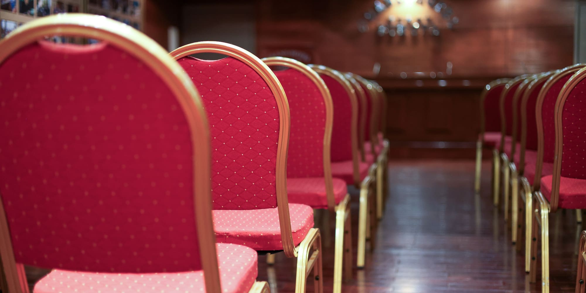 a row of red chairs in a room