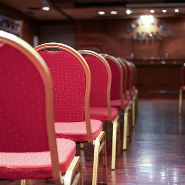 a row of red chairs in a room