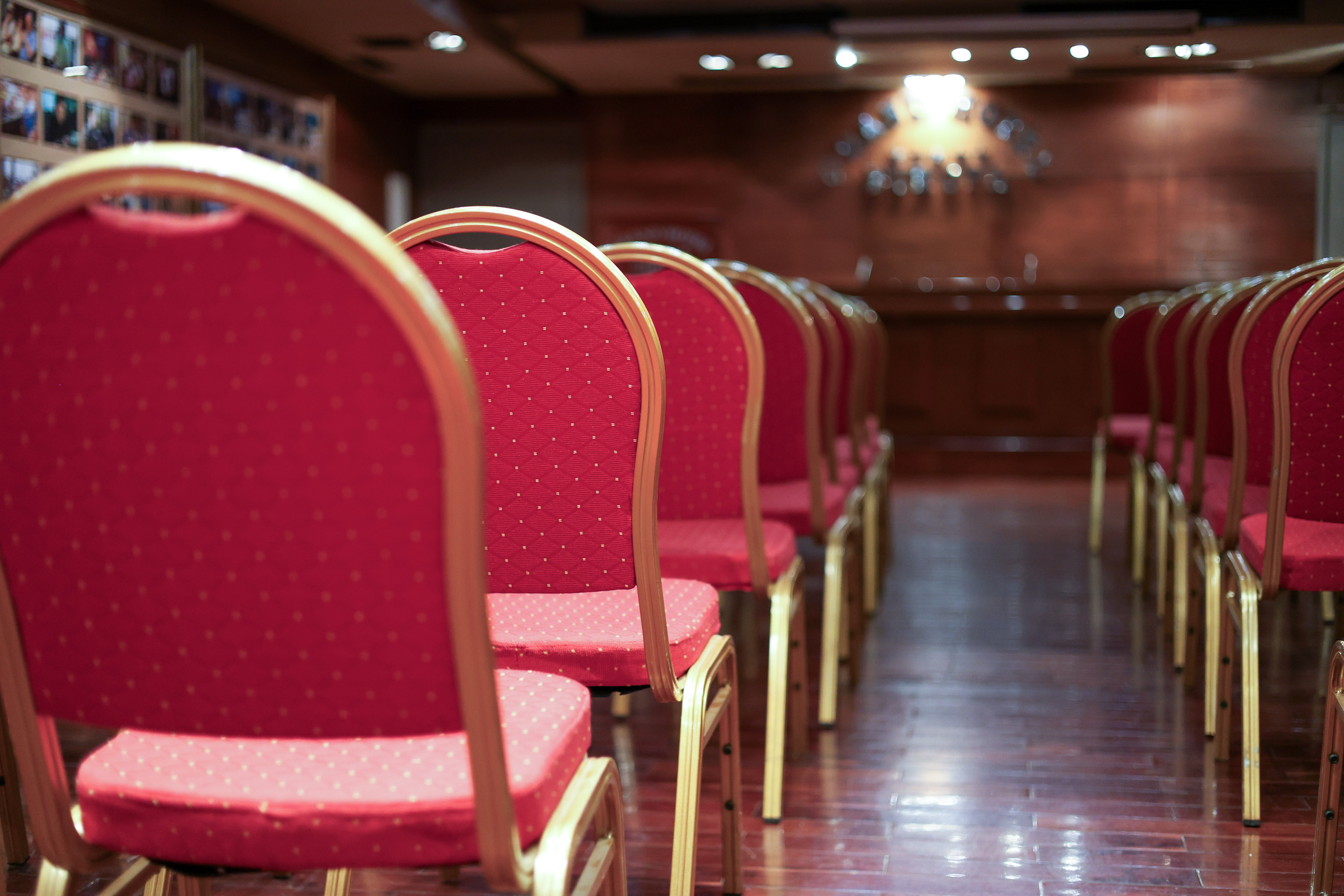 a row of red chairs in a room