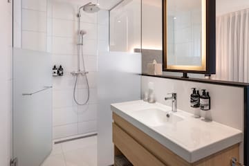 a bathroom with a shower and sink