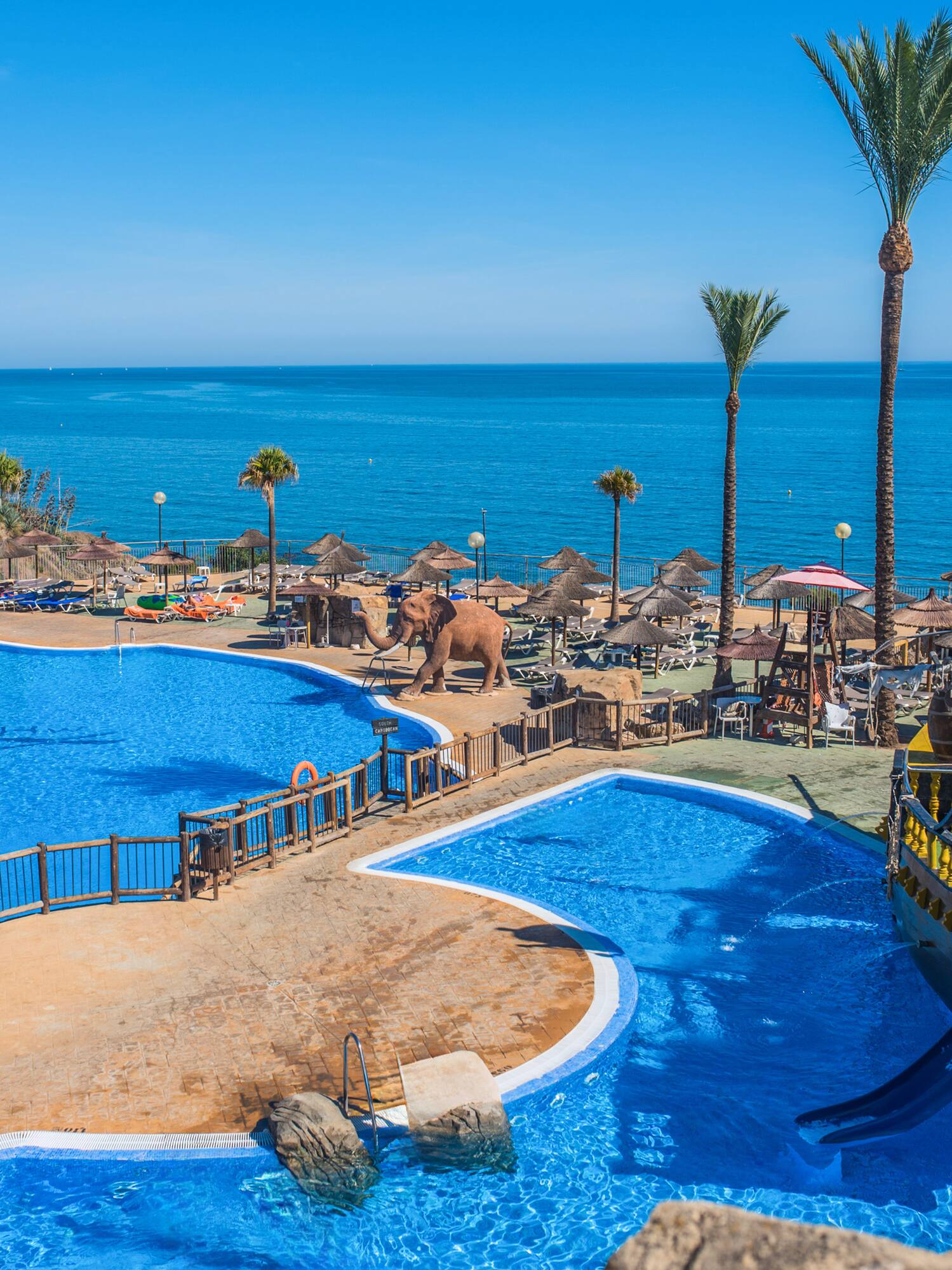 a large pool with a boat and a water slide