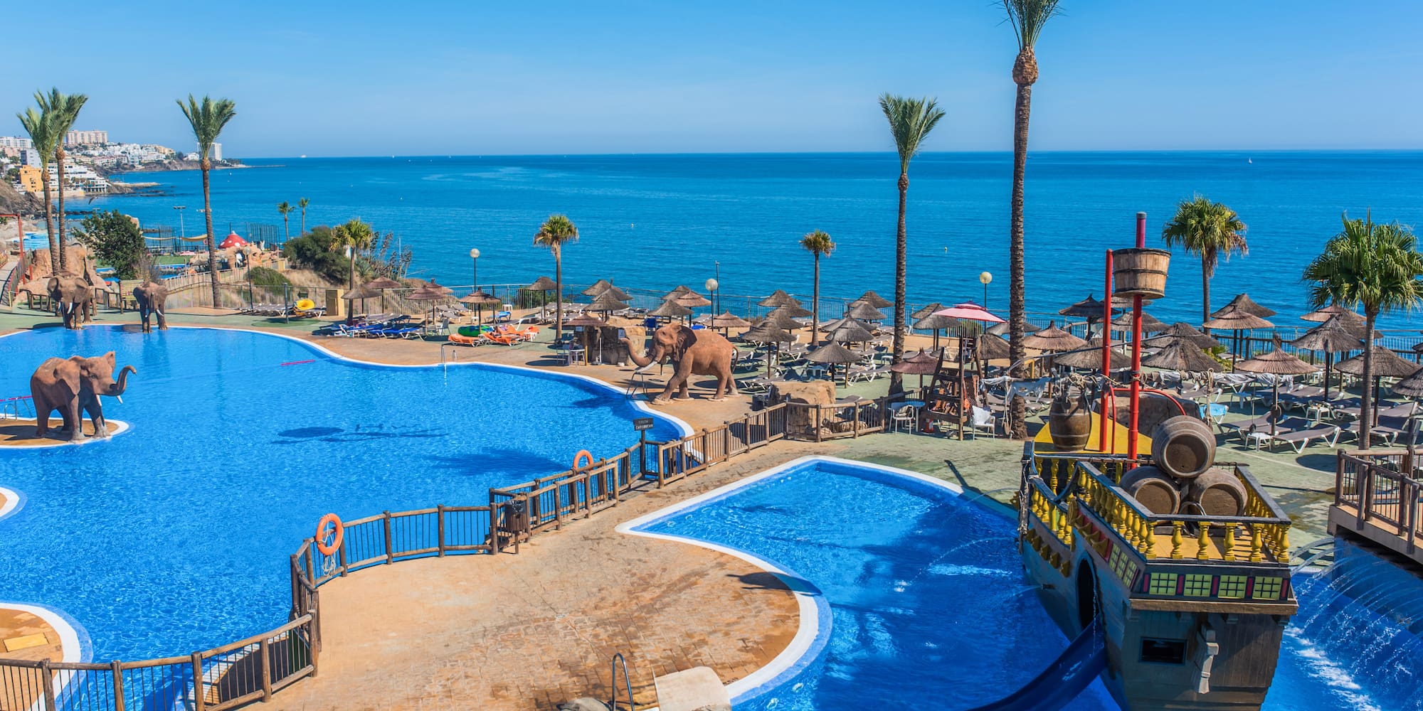 a large pool with a boat and a water slide