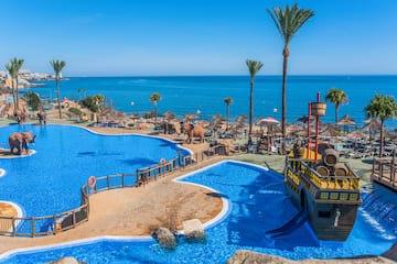 a large pool with a boat and a water slide