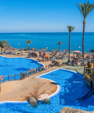 a large pool with a boat and a water slide