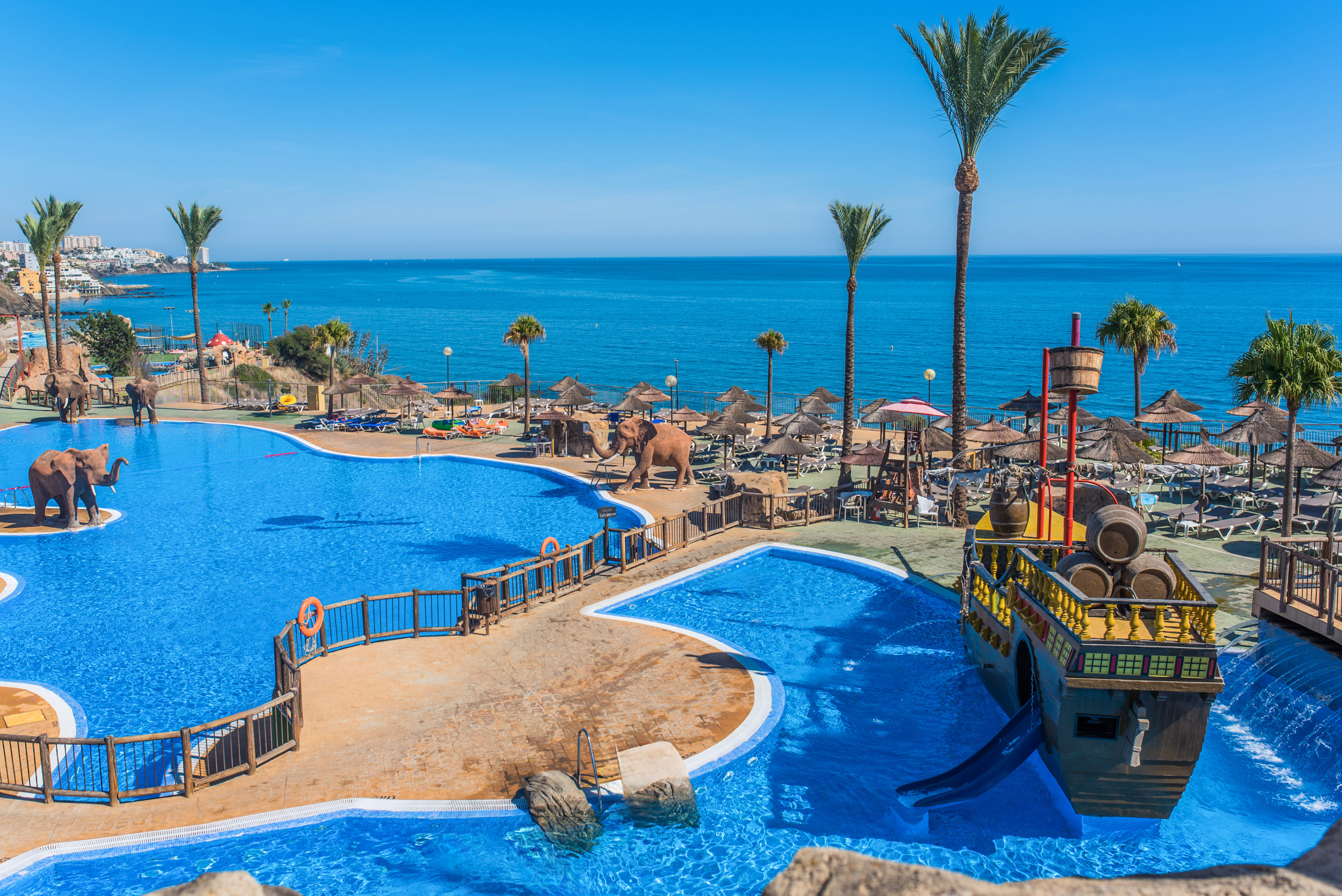 a large pool with a boat and a water slide