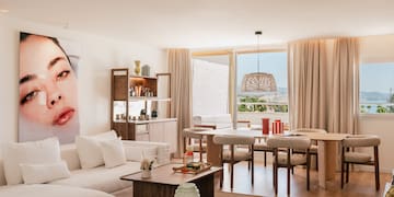 a living room with a table and chairs