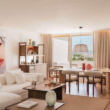 a living room with a table and chairs