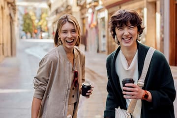 two women walking down a street
