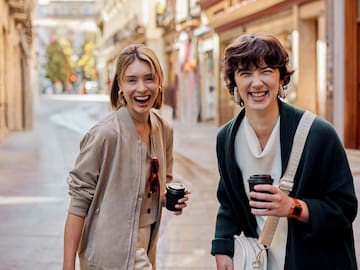 two women walking down a street