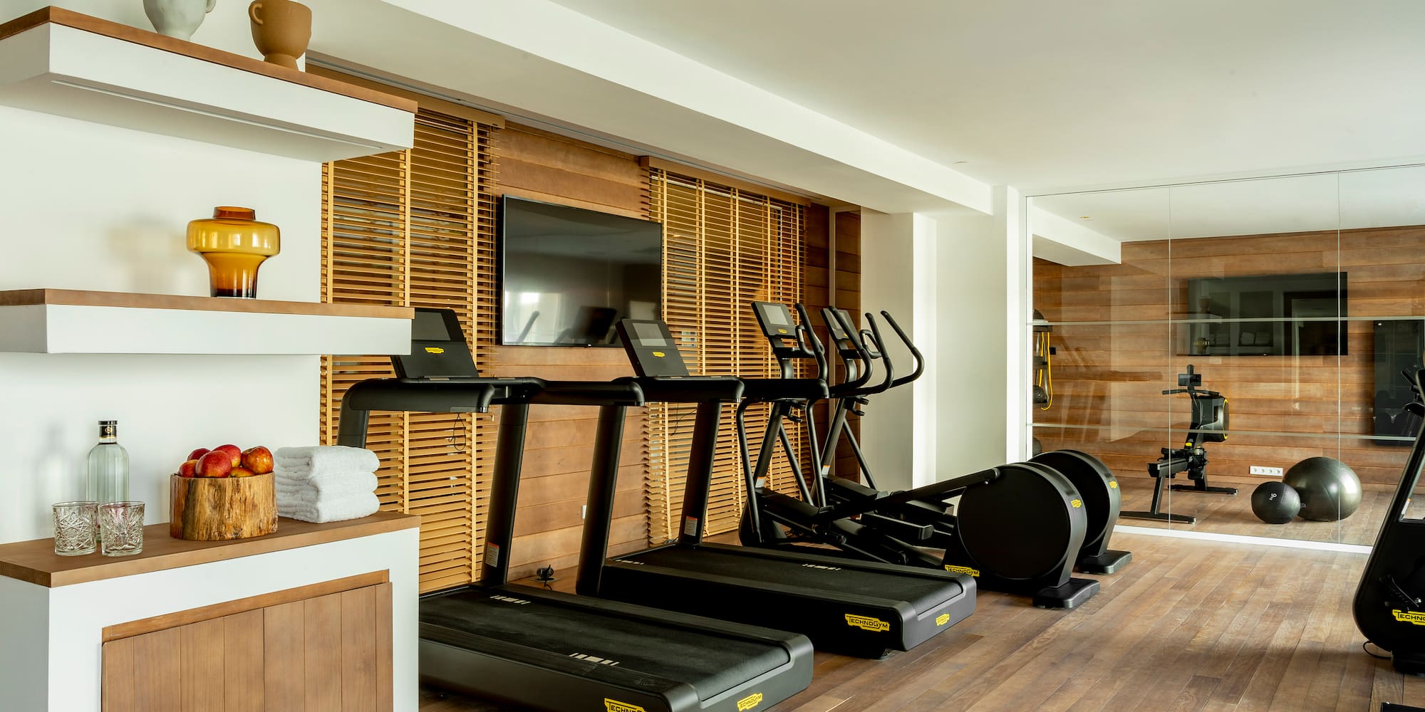 a room with treadmills and a tv