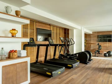 a room with treadmills and a tv