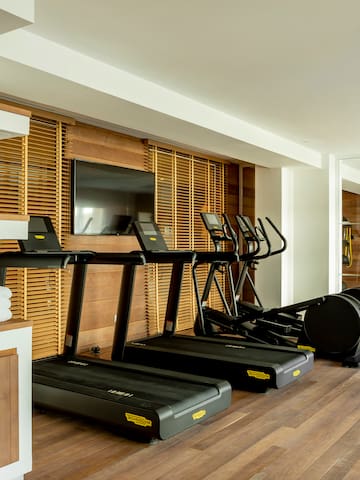 a room with treadmills and a tv