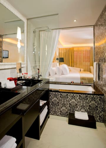 a bathroom with a bed and a bathtub