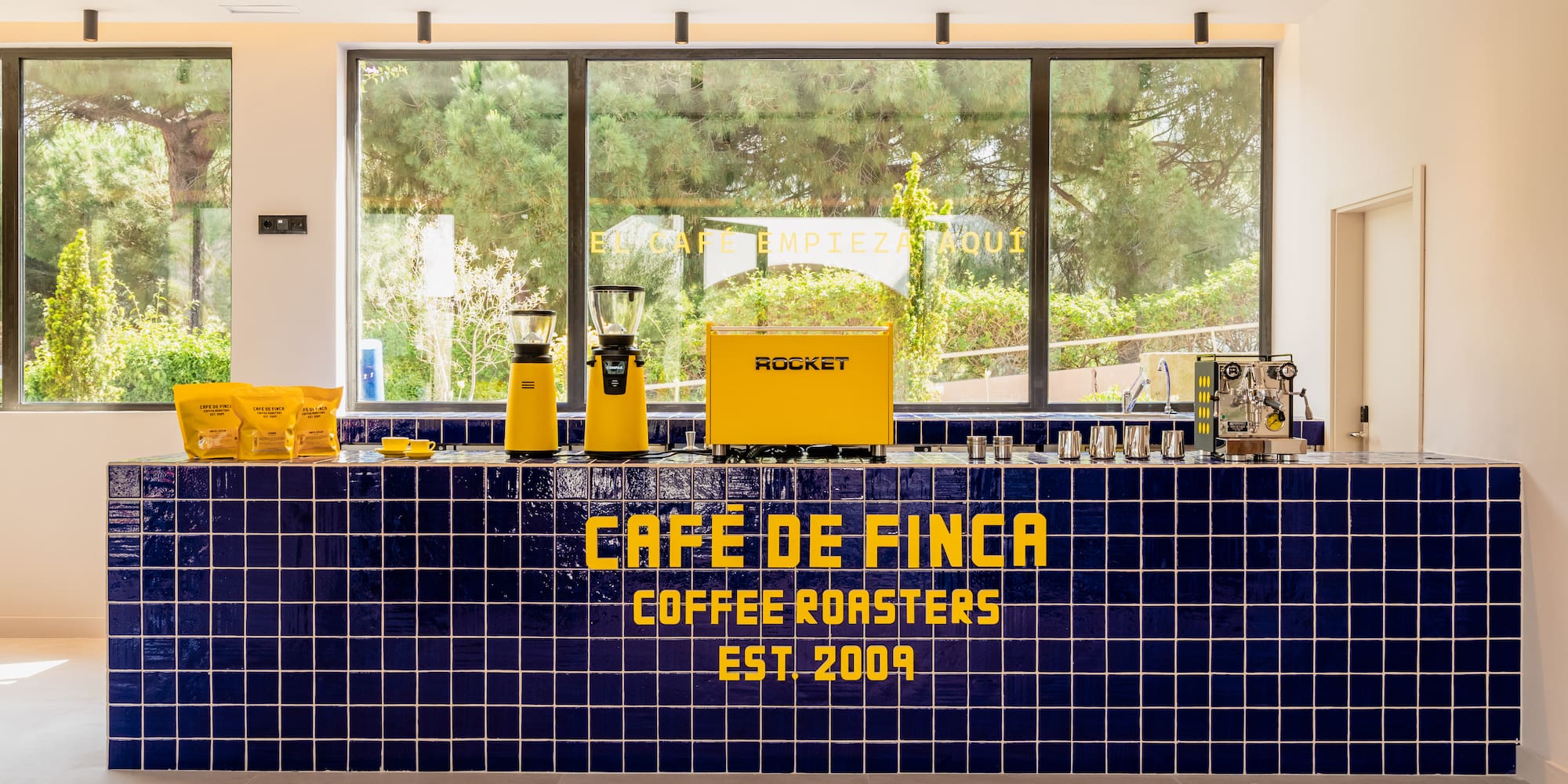 a counter with a yellow and blue tile wall