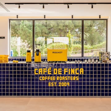 a counter with a yellow and blue tile wall
