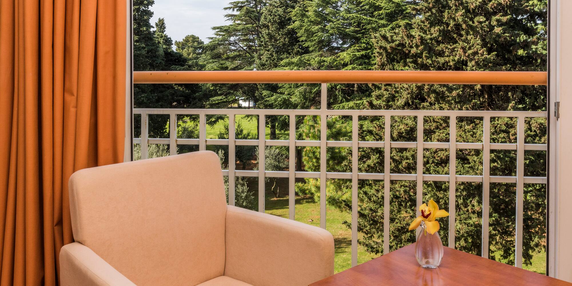 a chair and table on a balcony