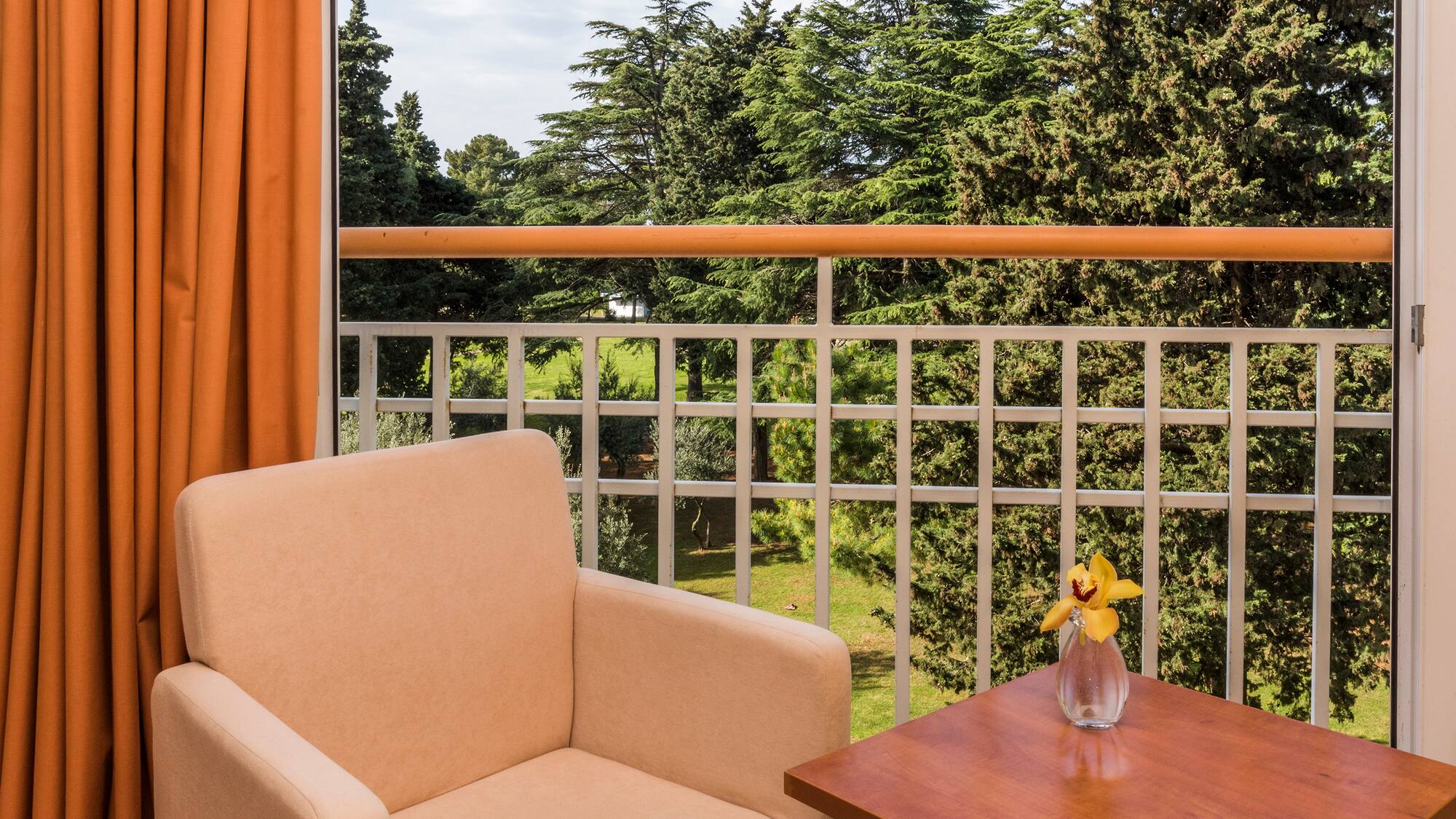 a chair and table on a balcony