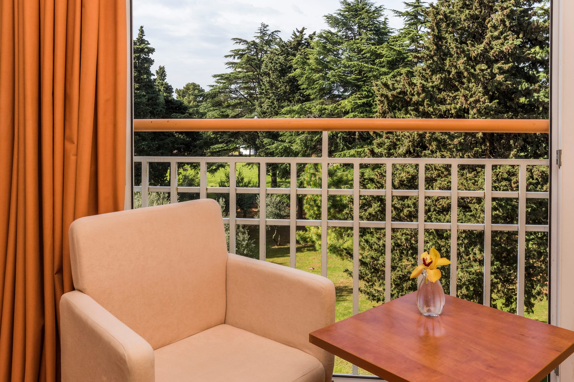a chair and table on a balcony