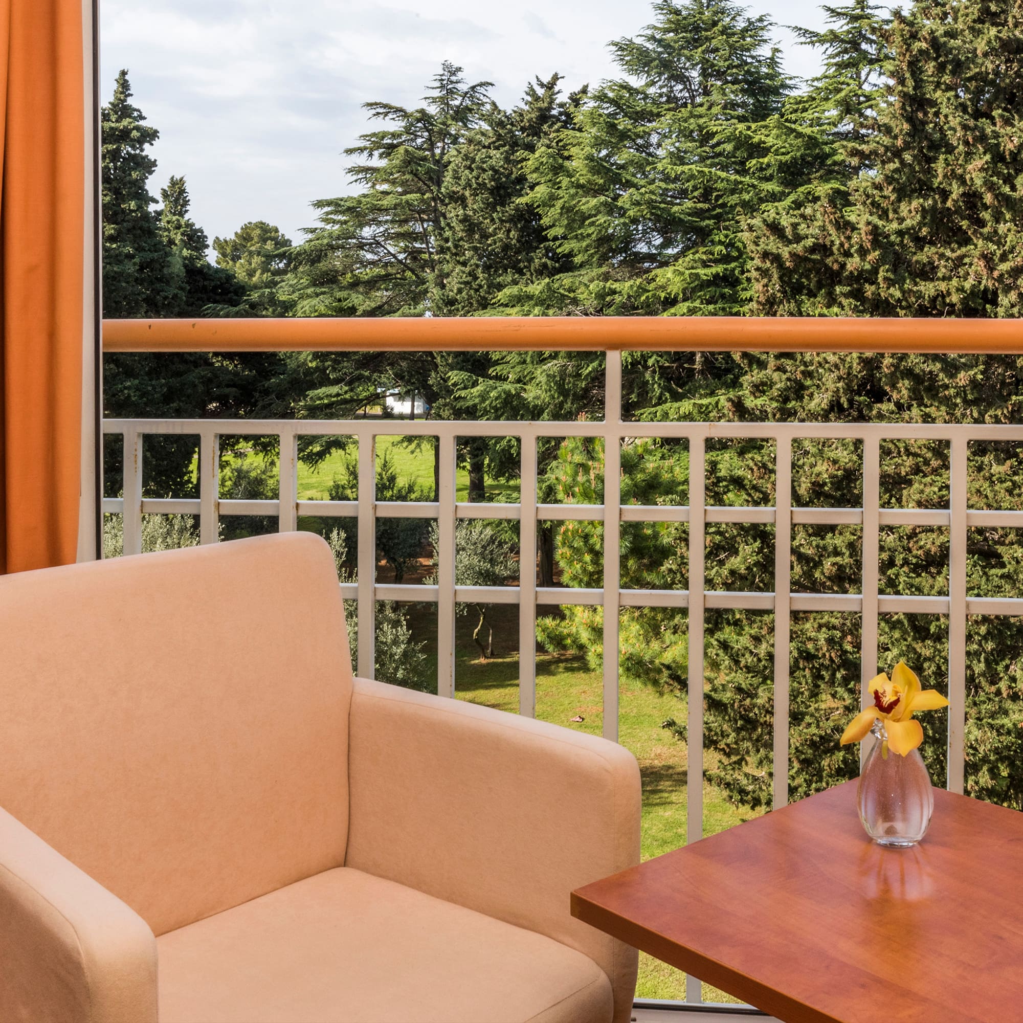 a chair and table on a balcony
