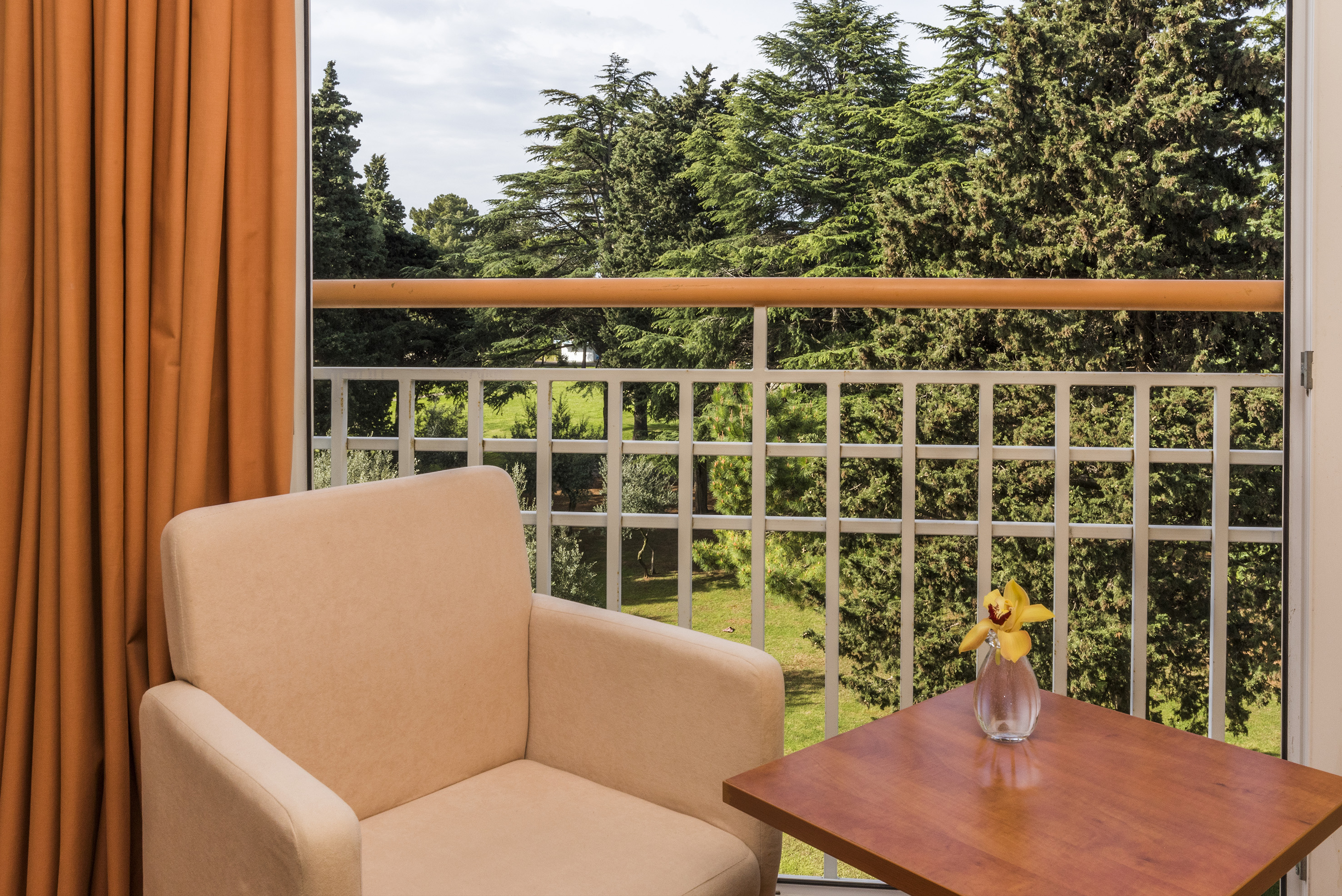 a chair and table on a balcony