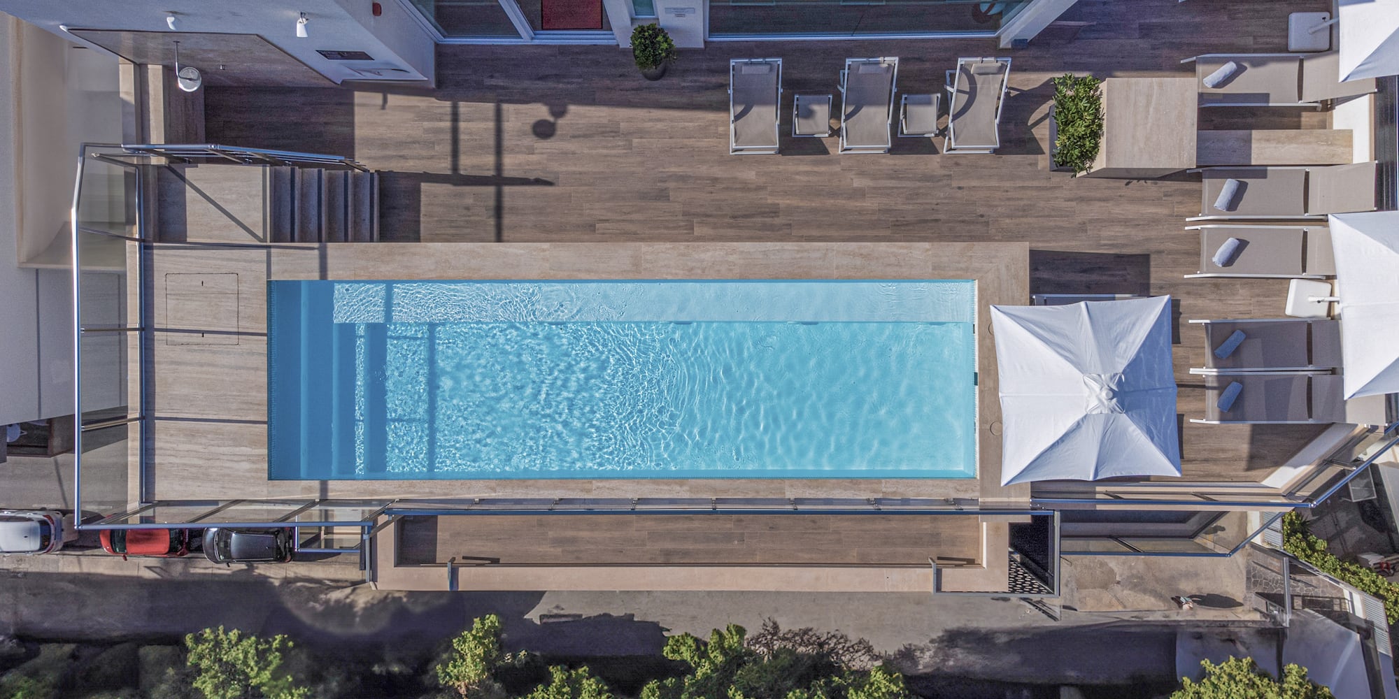 a pool with a deck and chairs