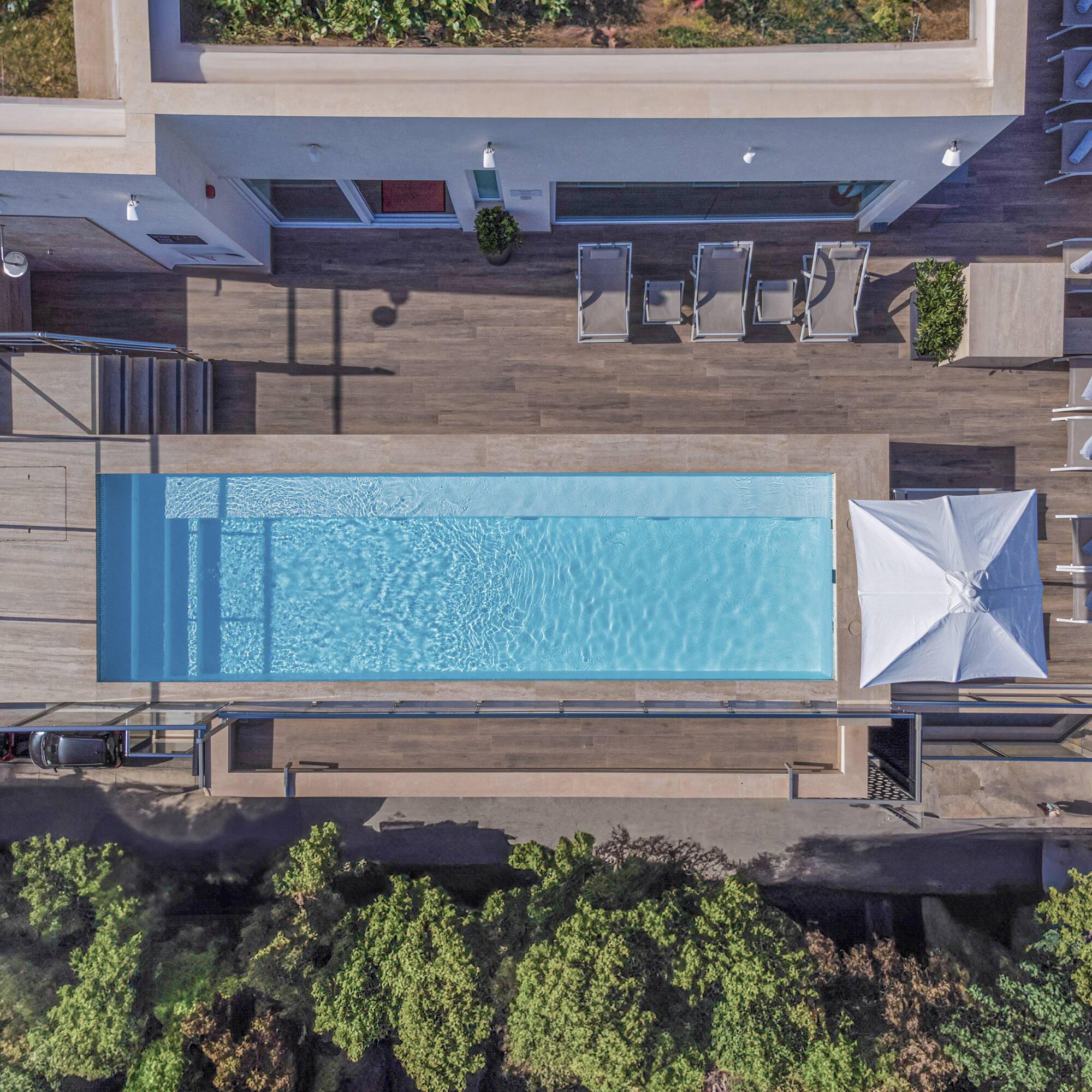 a pool with a deck and chairs