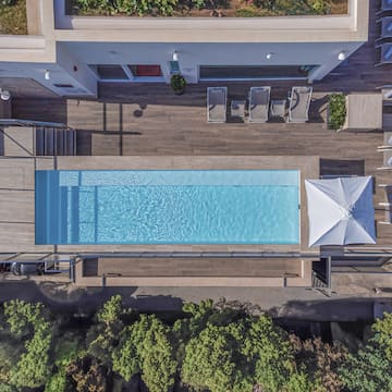 a pool with a deck and chairs