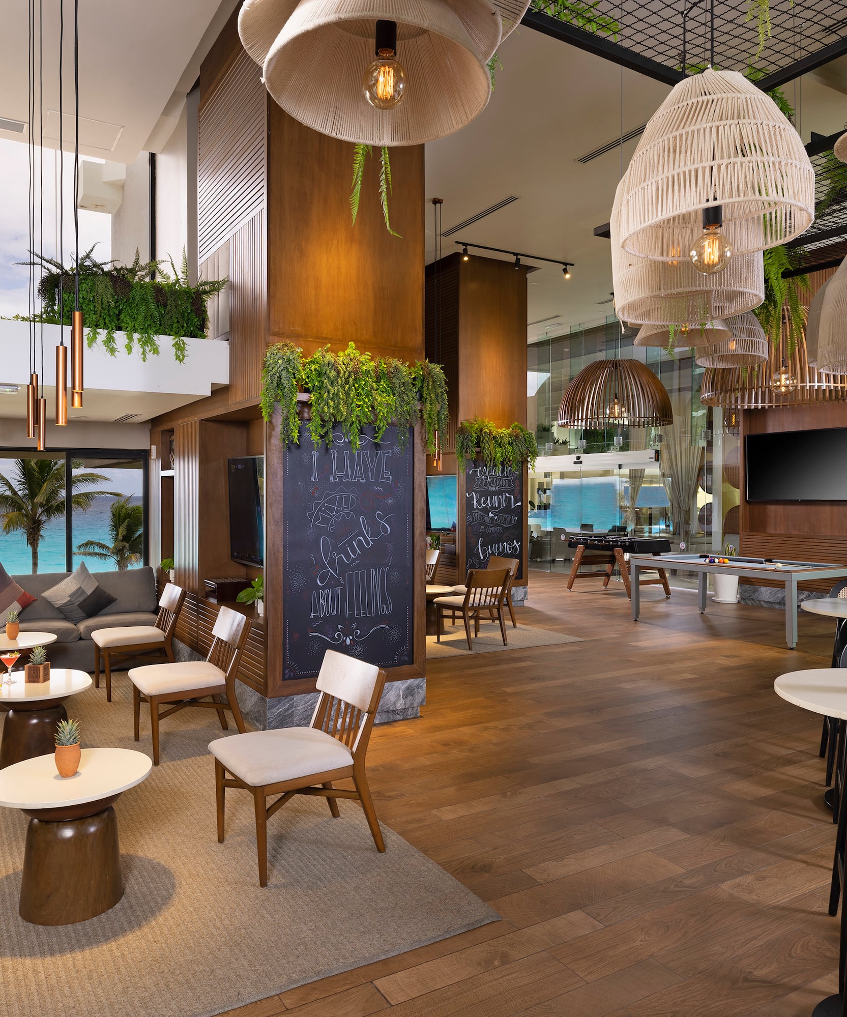 a room with tables and chairs and a chalkboard