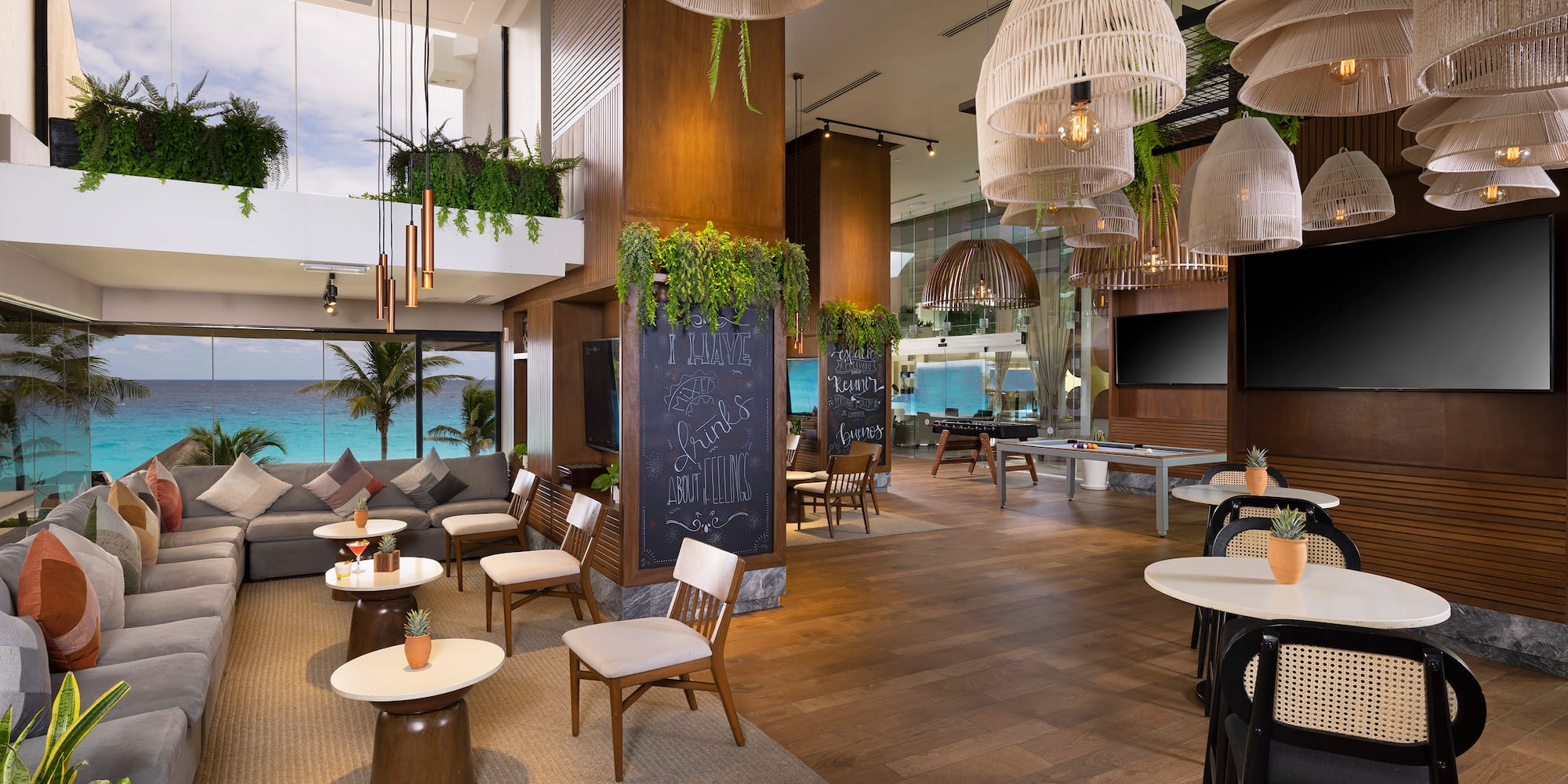 a room with tables and chairs and a chalkboard