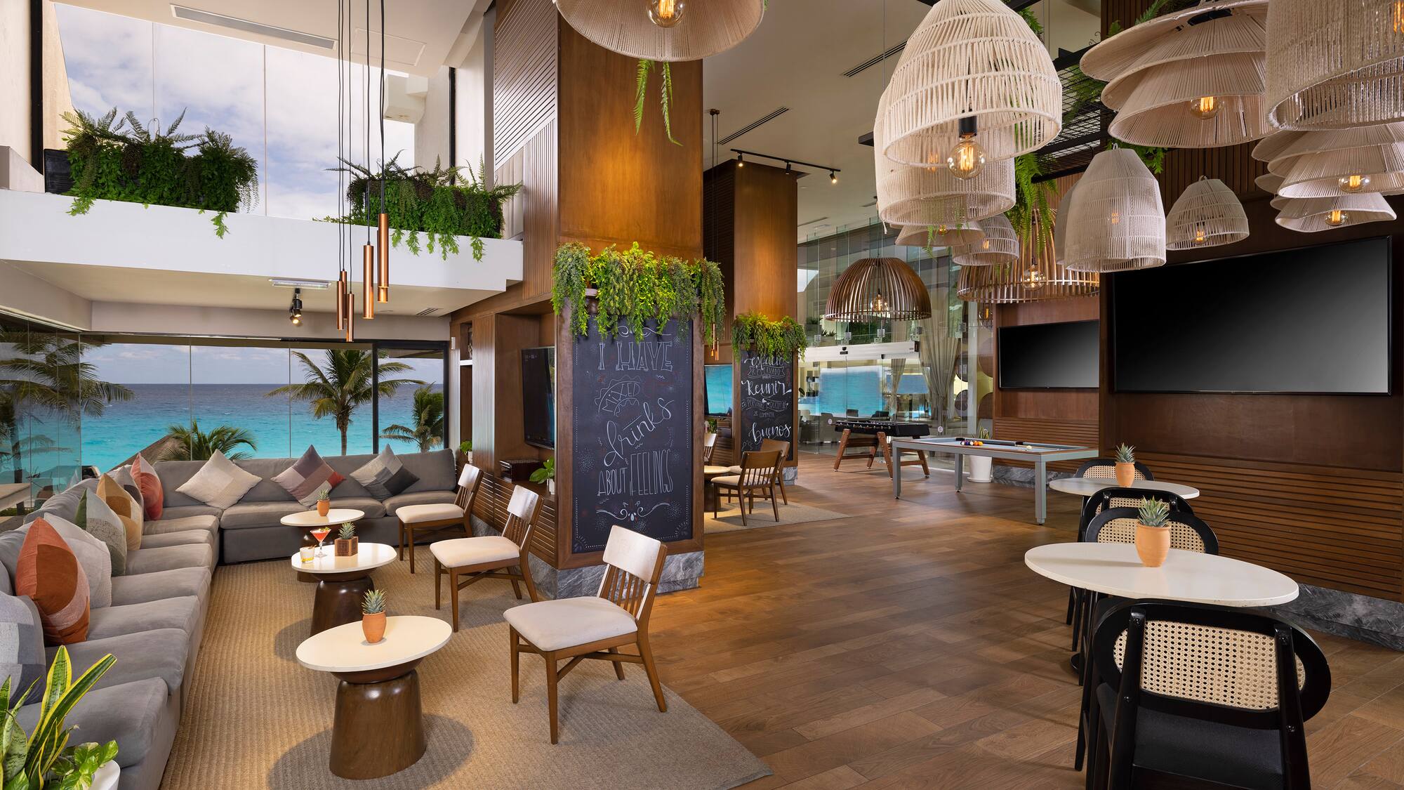 a room with tables and chairs and a chalkboard