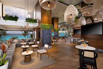 a room with tables and chairs and a chalkboard