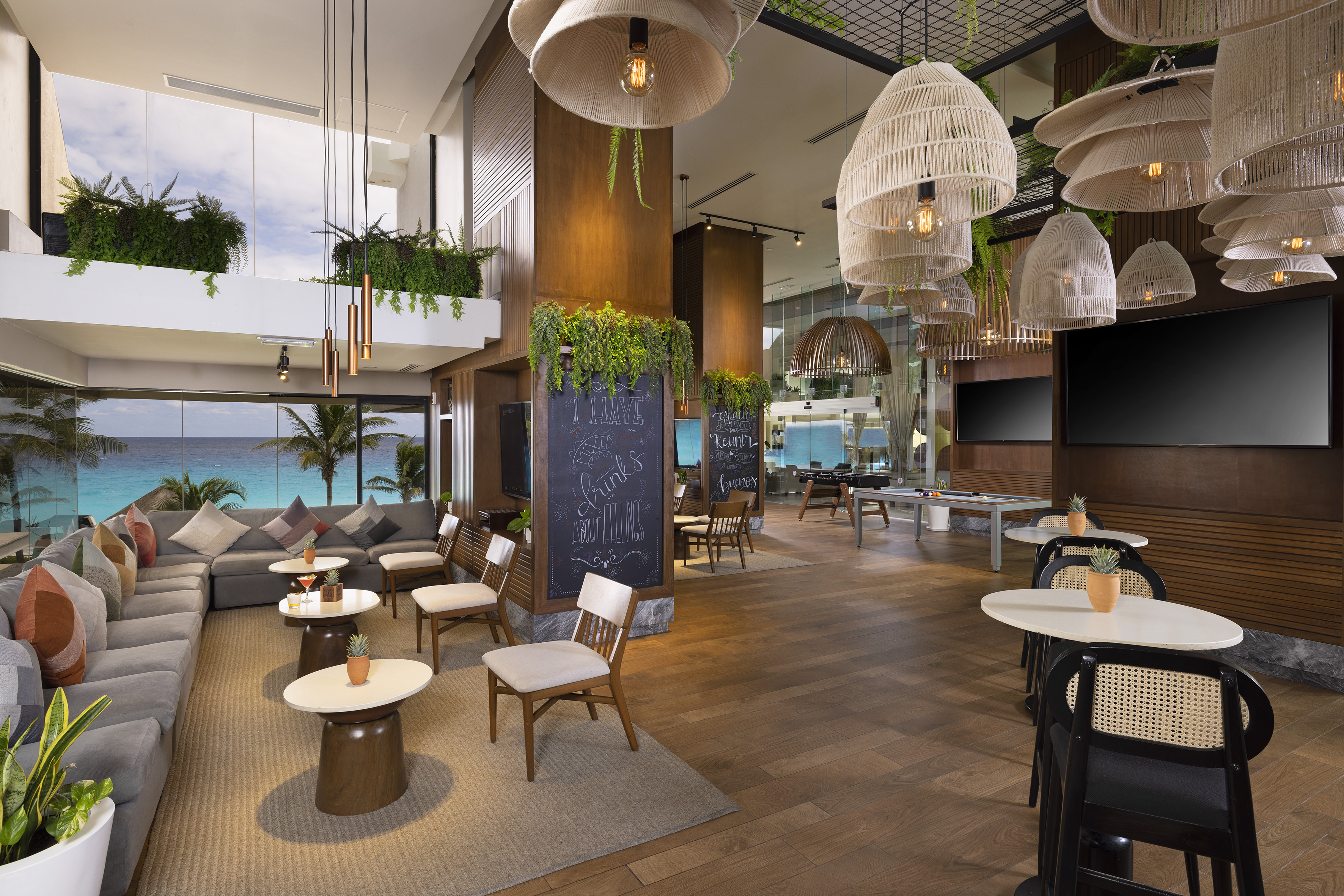 a room with tables and chairs and a chalkboard