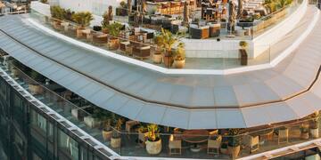 a rooftop of a building with a large city in the background