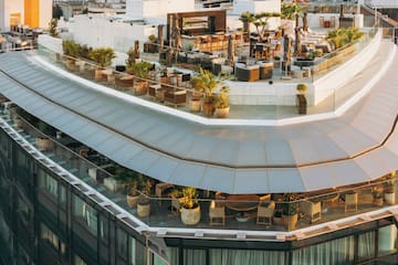 a rooftop of a building with a large city in the background