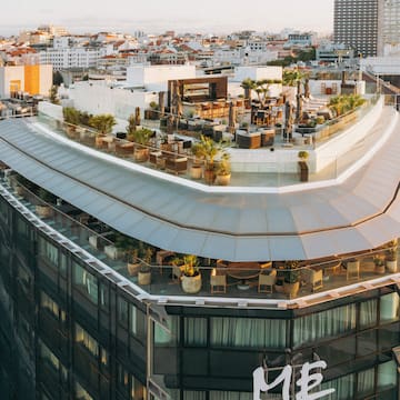 a rooftop of a building with a large city in the background