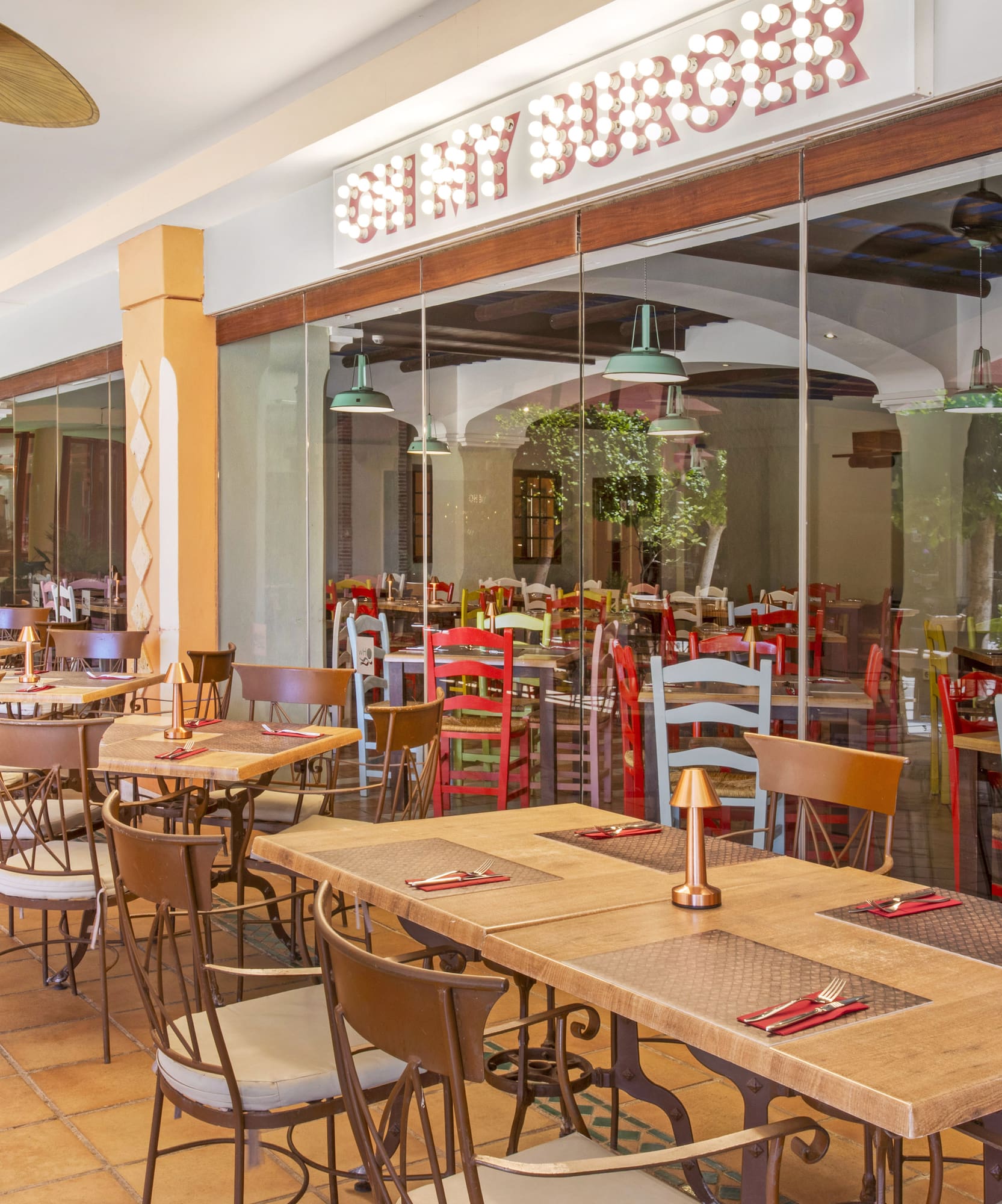 Shiny Burger restaurant outdoor dining patio with tables and chairs.