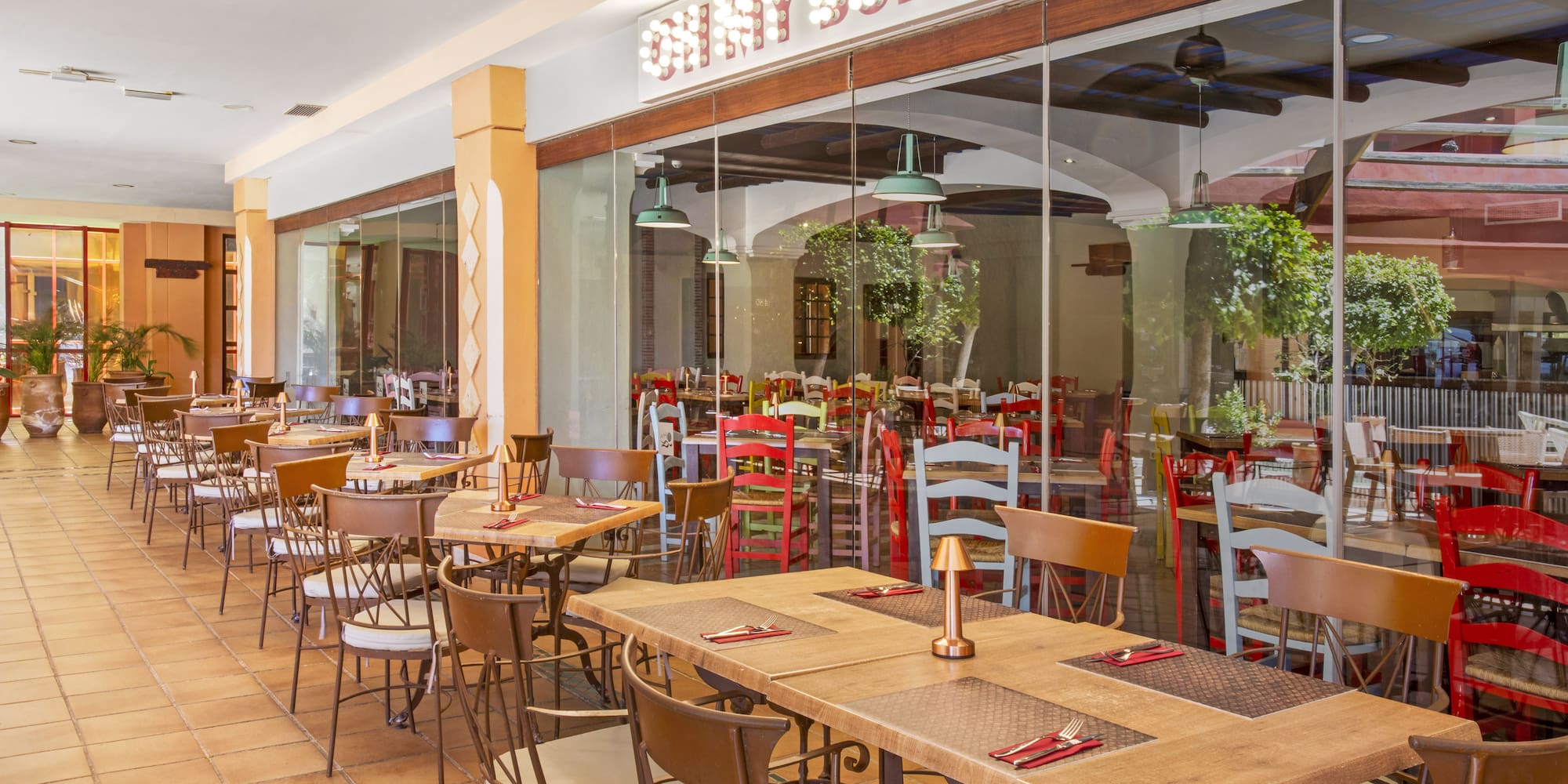 Shiny Burger restaurant outdoor dining patio with tables and chairs.