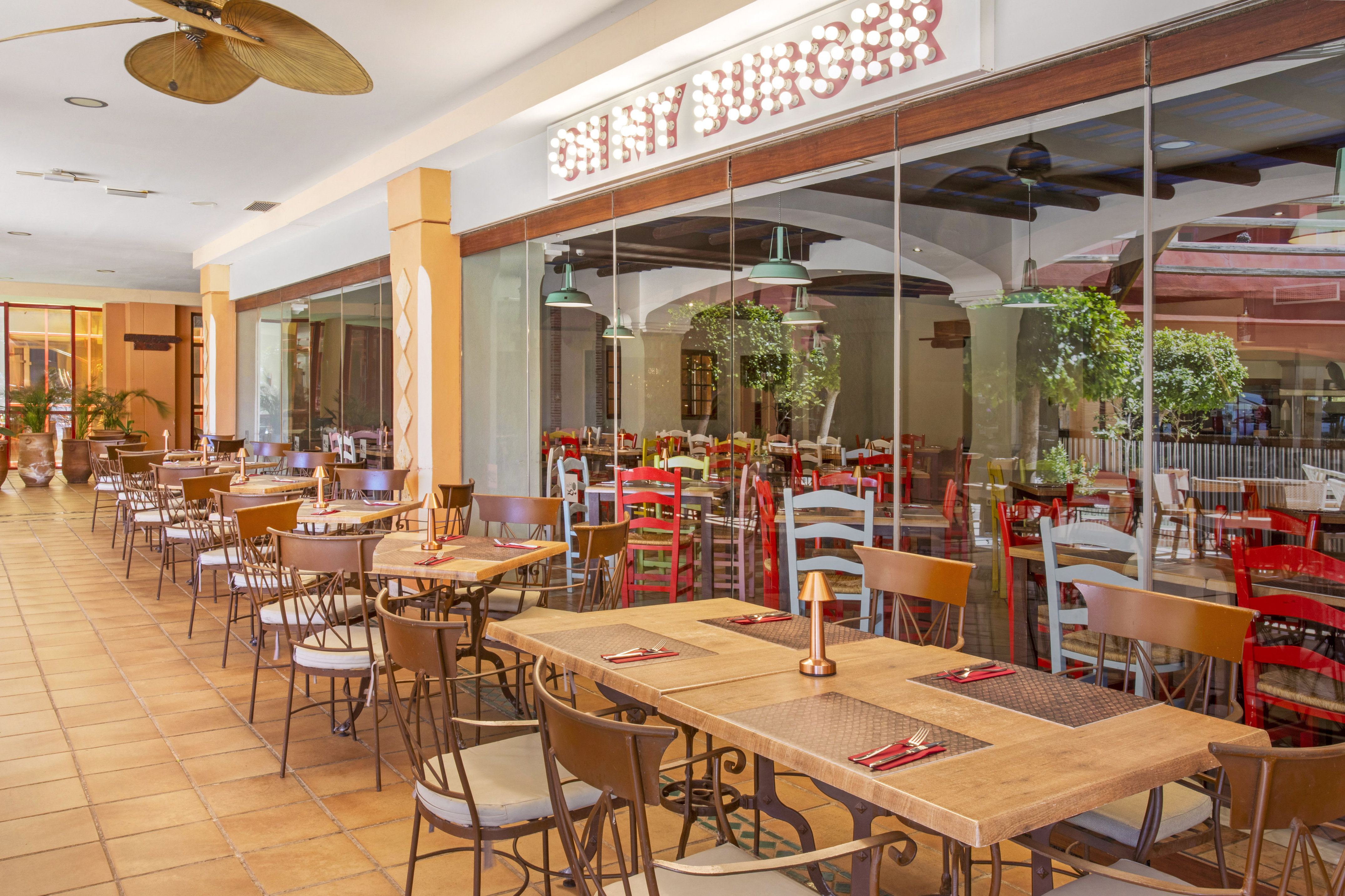 Shiny Burger restaurant outdoor dining patio with tables and chairs.