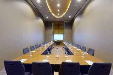 a room with a long table and chairs