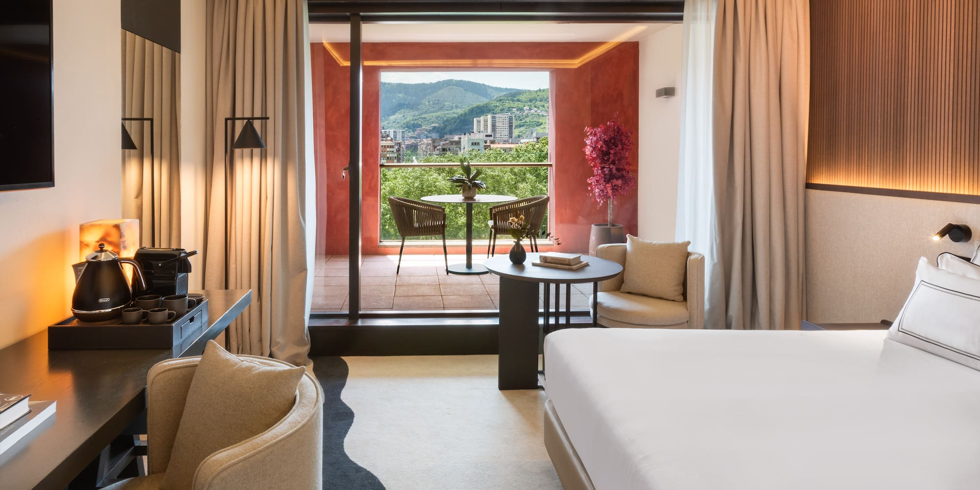 a room with a bed and a table and chairs