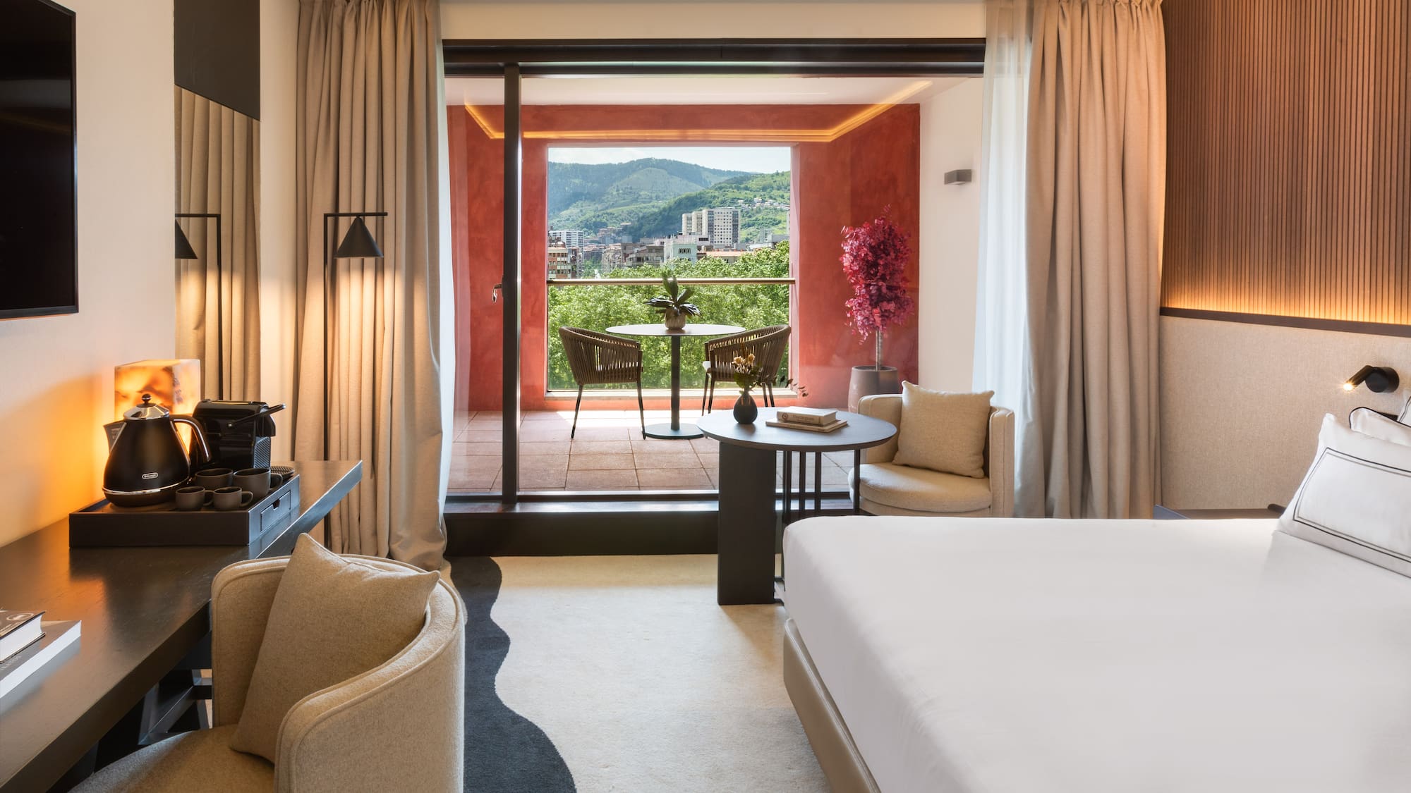 a room with a bed and a table and chairs