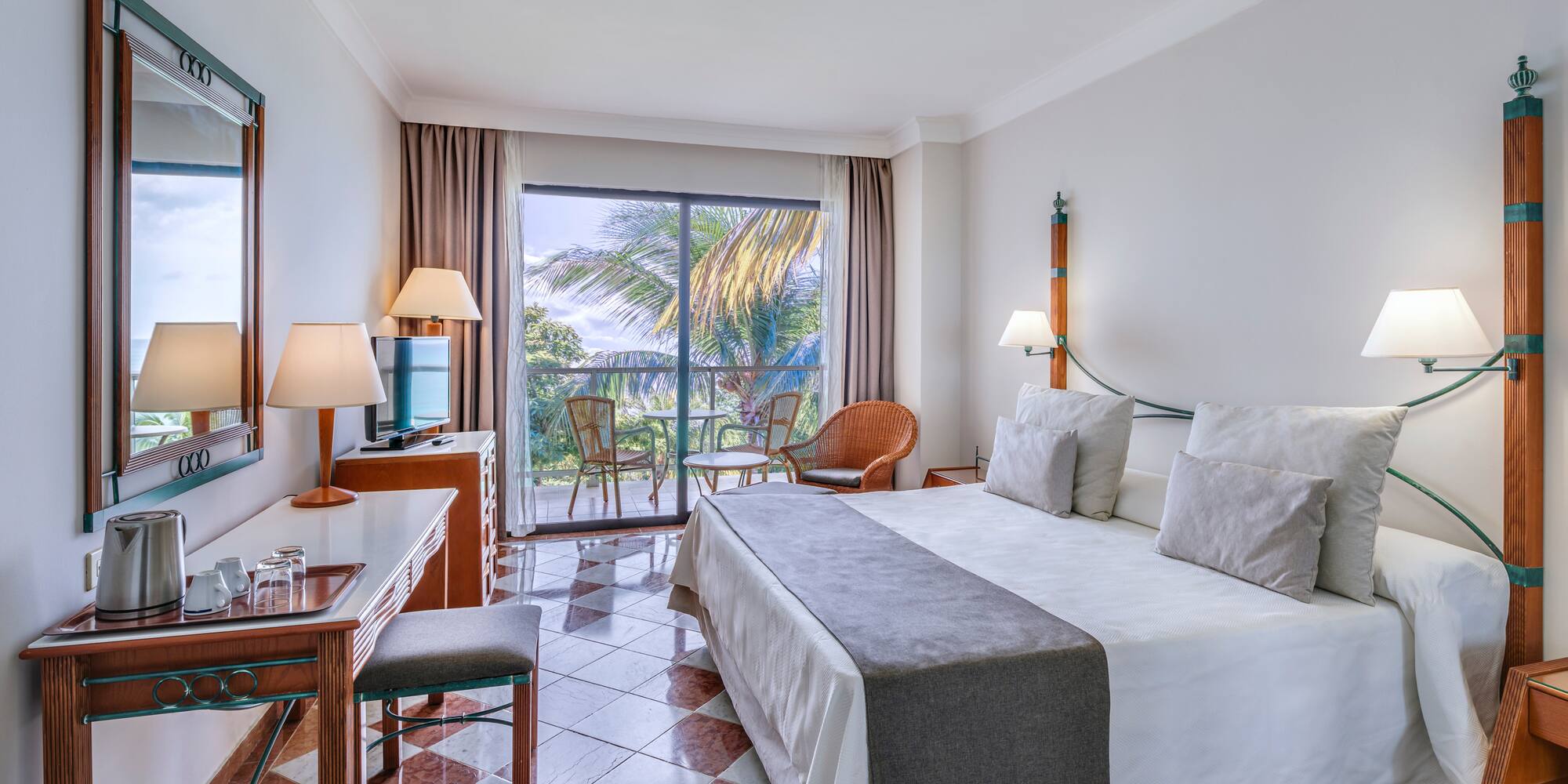 a room with a bed and a table and chairs