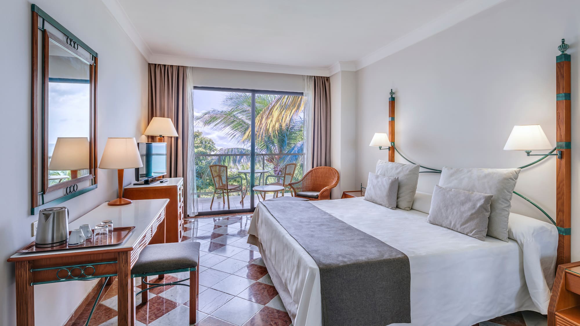 a room with a bed and a table and chairs